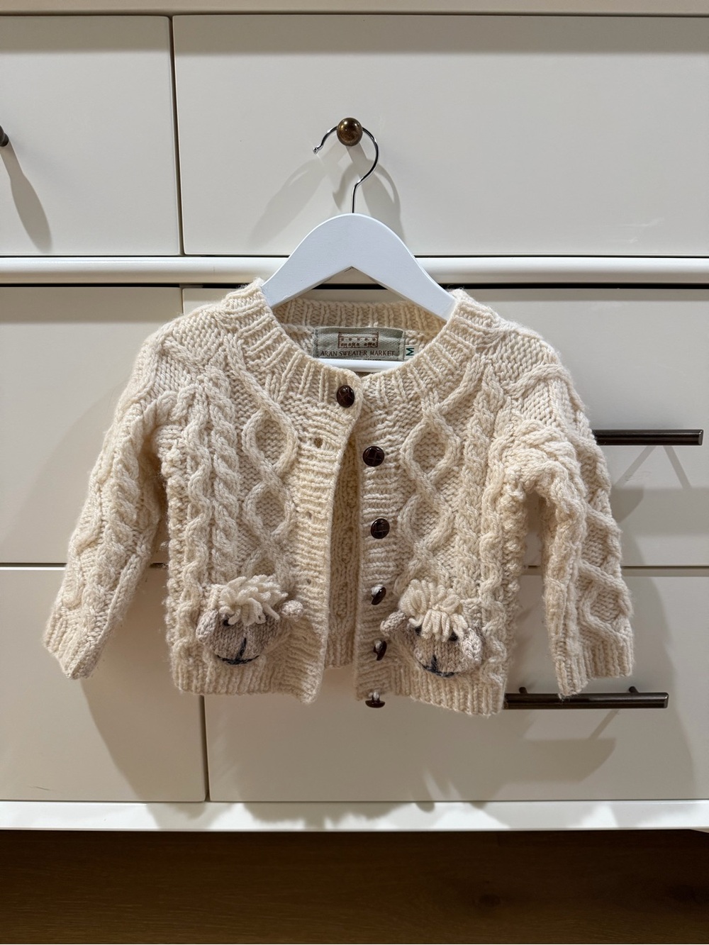 Cream Cable-Knit Baby Cardigan with Pom-Pom Pocket Accents
